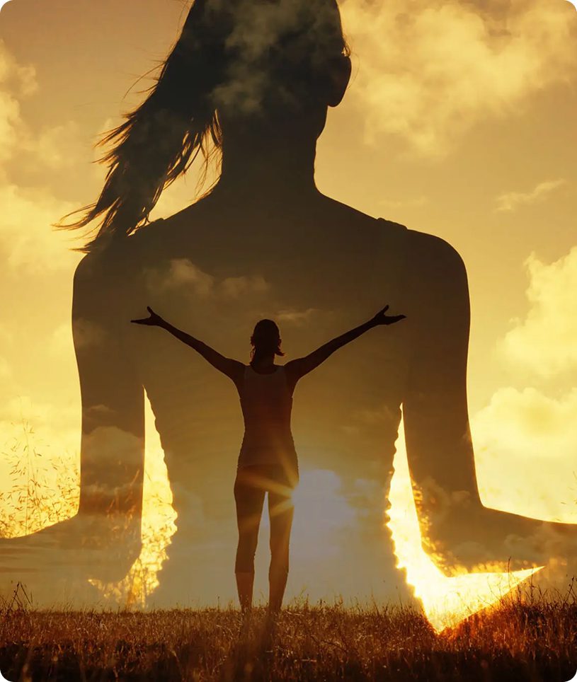 Silhouette of woman meditating at golden sunset